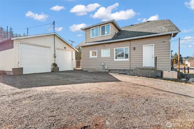 Rear of home and big two car garage, large driveway with pull-through alley access