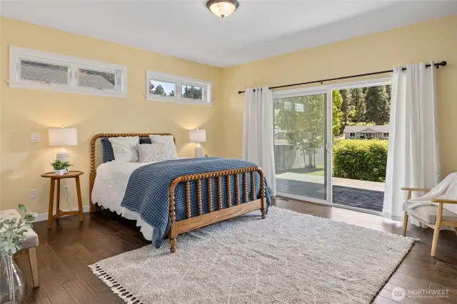 A peaceful retreat, the spacious master bedroom features a sliding glass door to the back porch with serene views, hardwood floors, and a walk-in closet. Ideal for unwinding after a long day.