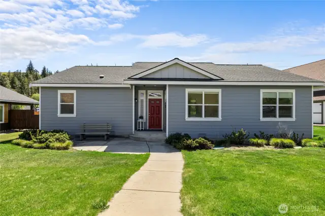 Charming covered entry with a welcoming walkway leading to a bright, inviting home.