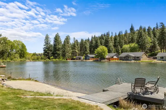 Expansive backyard with lush lawn, waterfront views, and space to relax or entertain.