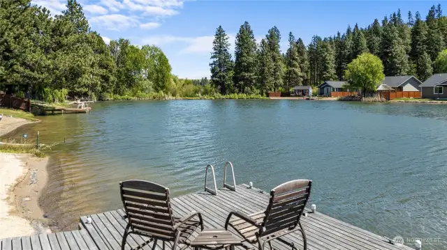 Private dock and waterfront view create an idyllic backyard retreat.