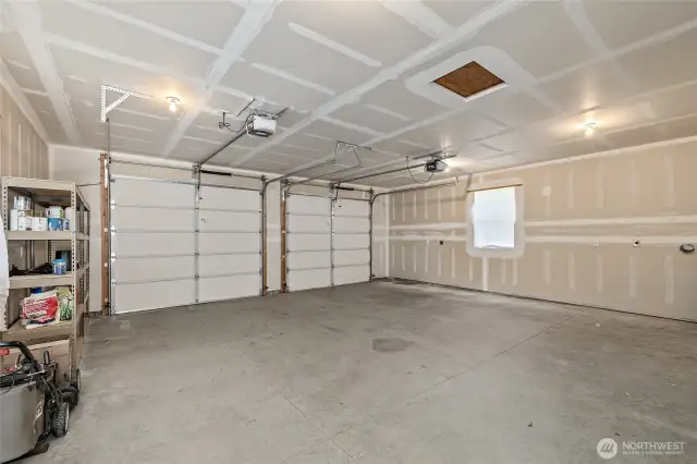 Oversized 2-car garage with ample storage space and a separate workshop area. Perfect for vehicles, tools, or outdoor gear.