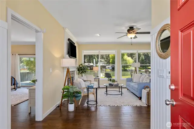 The front entryway boasts expansive windows, allowing natural light to fill the space. The open layout seamlessly transitions into the rest of the home, offering a perfect blend of functionality and style.