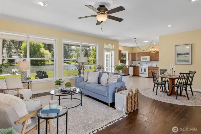 Spacious and sunlit living room with large windows that fill the space with natural light. The open floor plan is perfect for entertaining or relaxing with family.