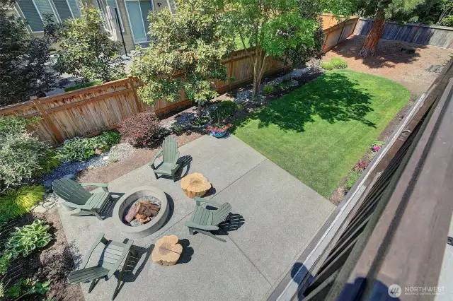 Deck overlooks landscaped level backyard