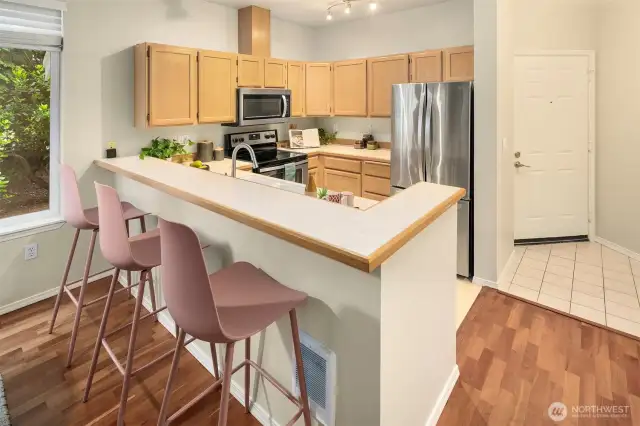 Enter your tucked away corner unit to high ceilings and your sweet kitchen! Note the stainless appliances and breakfast bar. This home has been kept in immaculate condition and freshly painted throughout.