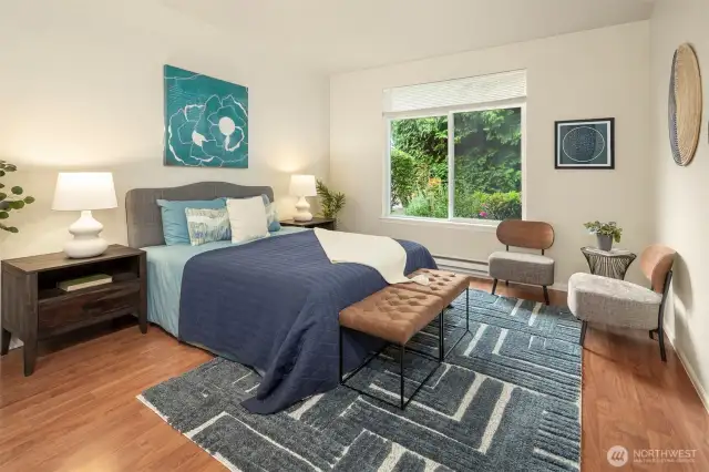 The primary bedroom is quite large, with two closets and high ceilings. More green views here!