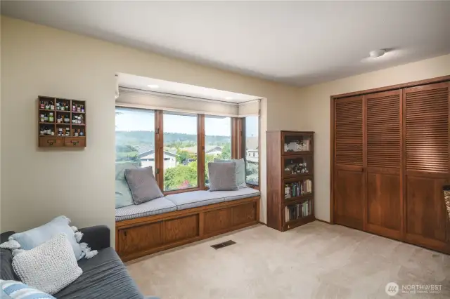 Guest bedroom with window seat to enjoy some sneak peeks of the channel!