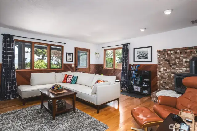 Family room with gas fireplace, wood floors and custom wainscoting. Walk out to the spacious backyard and sundeck.