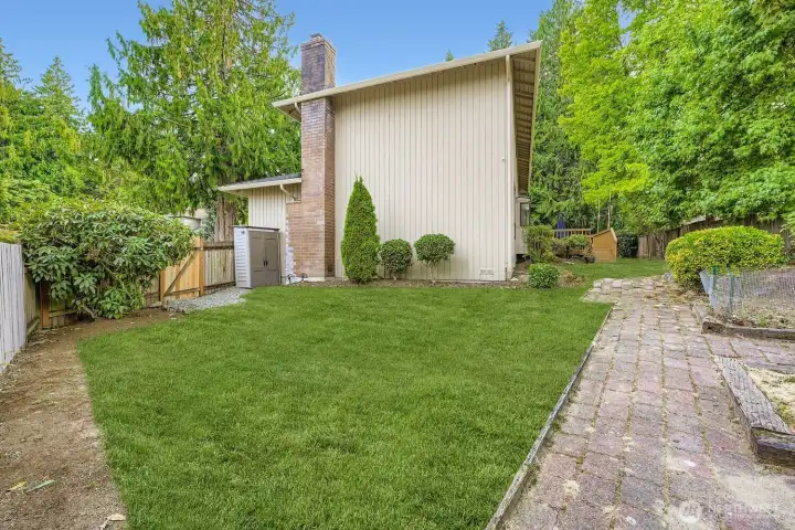 From the east side of the yard, you'll find a small work shed, brick pathways, raised gardens and a new gate.