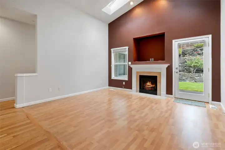 Naturally lit living room with cozy fireplace