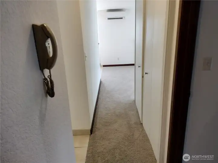 As you go down the hallway, you will find two bedrooms and 1 3/4 bathrooms.