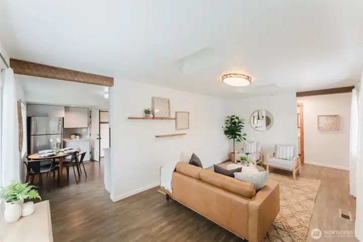 Open-concept living area with warm details and easy connection to the dining space and kitchen.