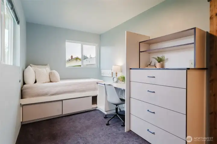 Custom built-in bed and desk create a functional, space-saving room—ideal for a home office, guest room, or flex space.