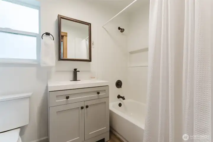 Renovated full bathroom with modern finishes and a clean, timeless design.