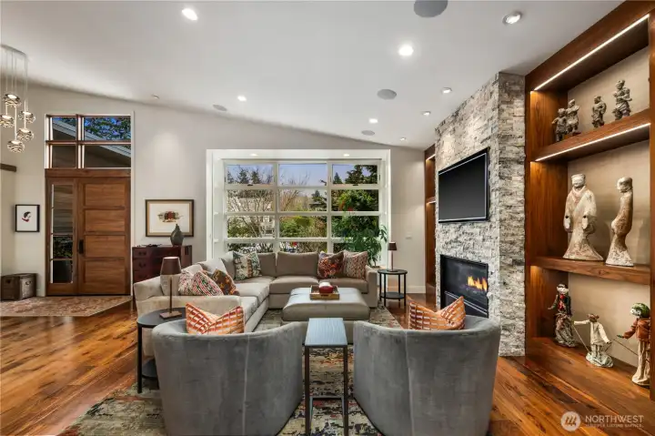 The living room...vaulted ceiling, gas fireplace flanked by built-in shelving on both sides.