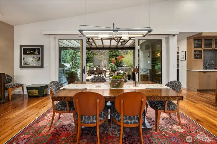 In the same greatroom, the dinig area which opens out to teh covered patio, the garden & BBQ station.