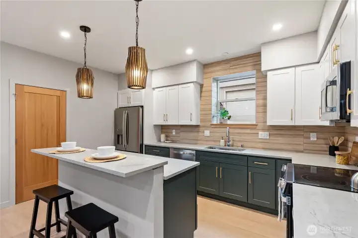 Complete with quartz countertops, stainless steel appliances and a pantry closet, this kitchen has everything you need.
