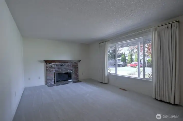 Living room with gas fireplace and huge picture window