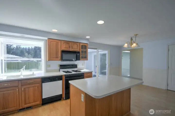 All appliances are included in this well-designed kitchen. Central island for food prep and bar seating, windows to enjoy the backyard view and room for a large eat-in kitchen table