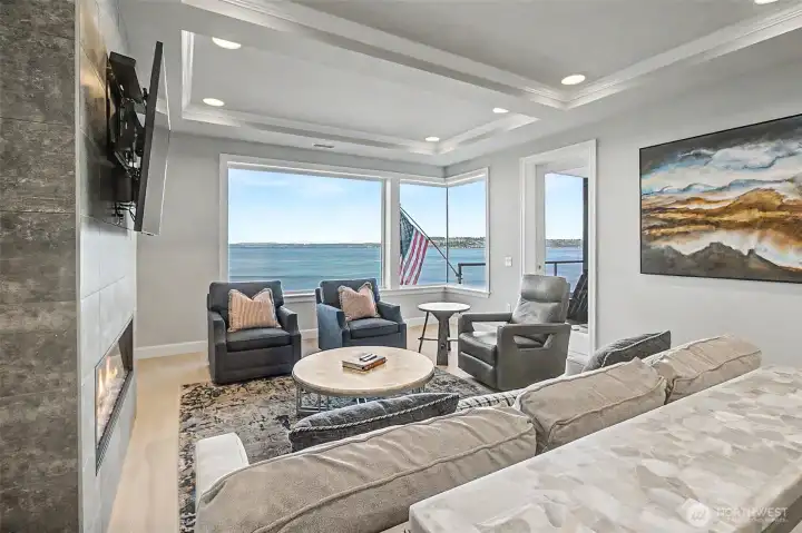 Light-filled living area with expansive windows framing dynamic waterfront views.