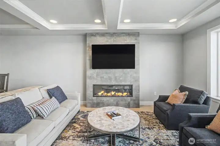 Contemporary living area featuring a statement fireplace and refined finishes.