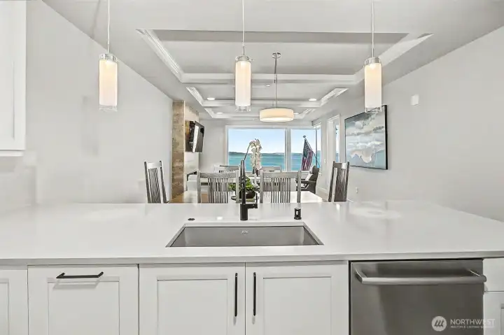 Oversized counters anchor the kitchen, perfect for prep, dining, and entertaining.