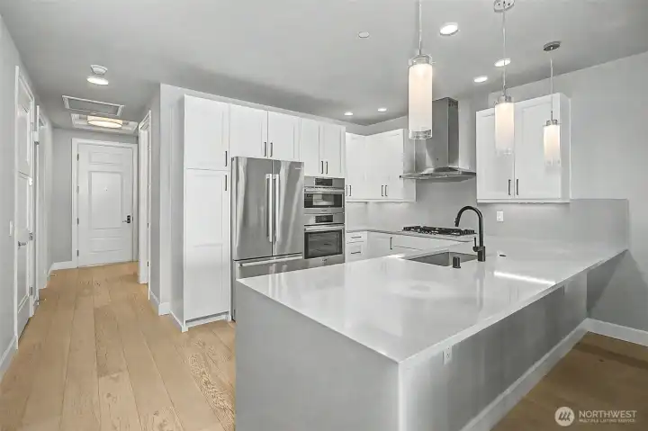 Custom cabinetry and sleek finishes create a polished, modern kitchen aesthetic.