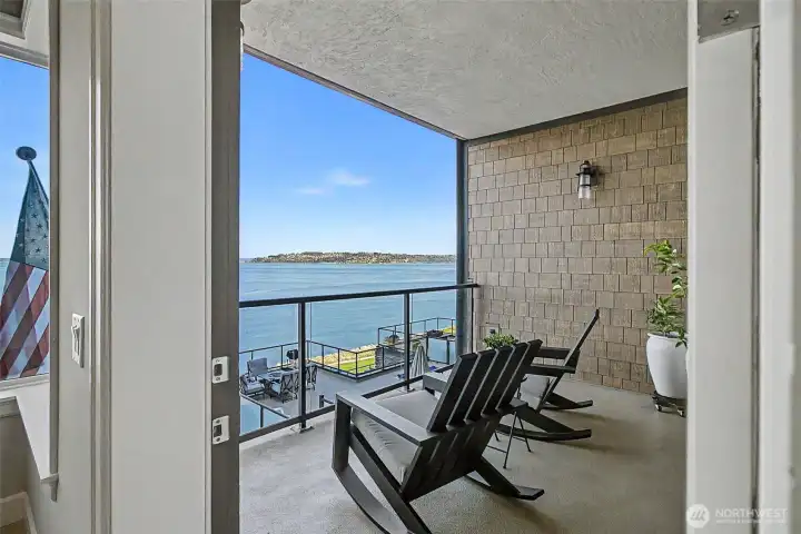 Covered balcony provides a peaceful setting to enjoy fresh saltwater air year-round.