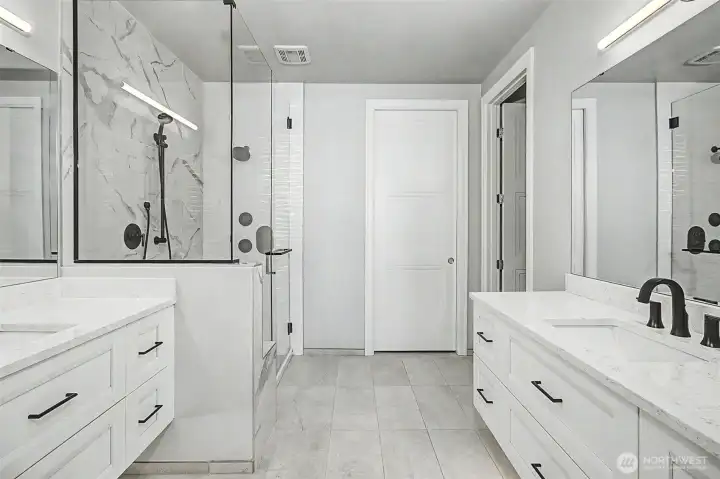 Spa-inspired primary bath with dual vanities and refined finishes.