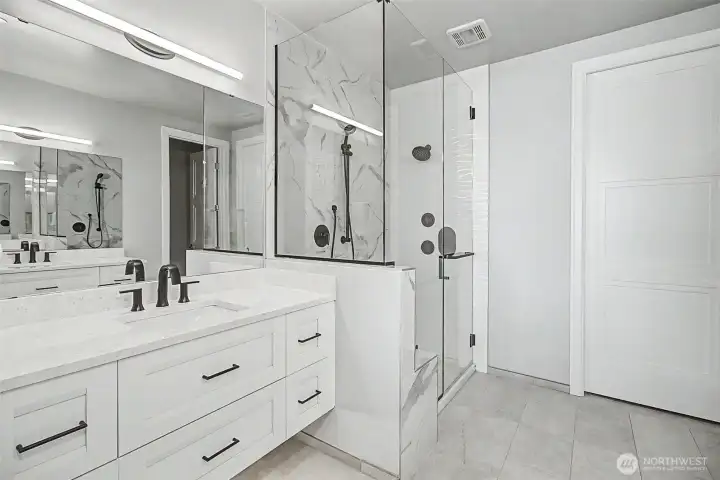 Walk-in shower and heated floors create a luxurious daily experience.