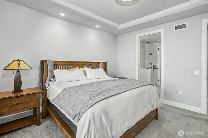 Spacious primary bedroom with refined finishes and a calm, understated design.