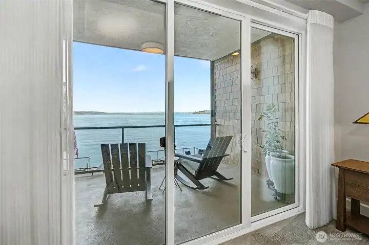 Balcony access extends the living space outdoors with uninterrupted water views.