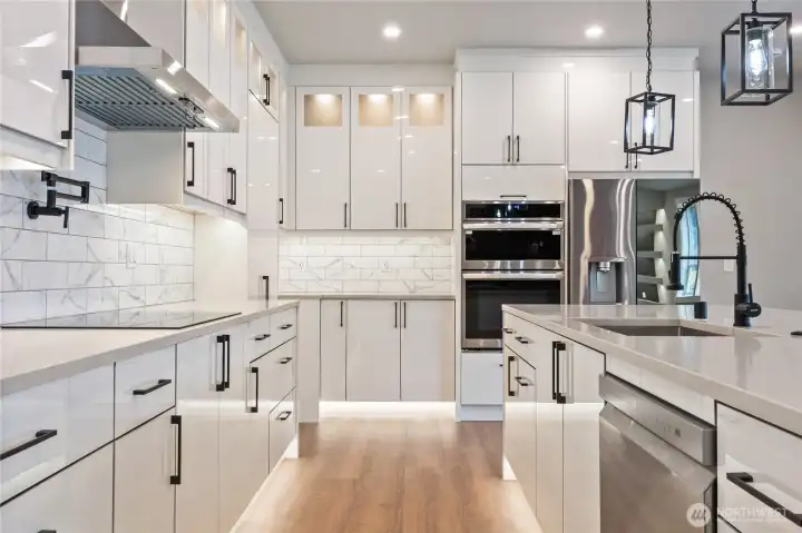Kitchen featuring full-height cabinetry, marble tile backsplash, and LG appliance package