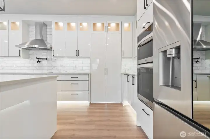 Full kitchen view showcasing cabinetry depth and under-cabinet LED lighting