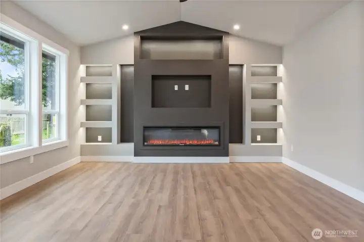 Electric fireplace with custom surround and built-in shelving detail