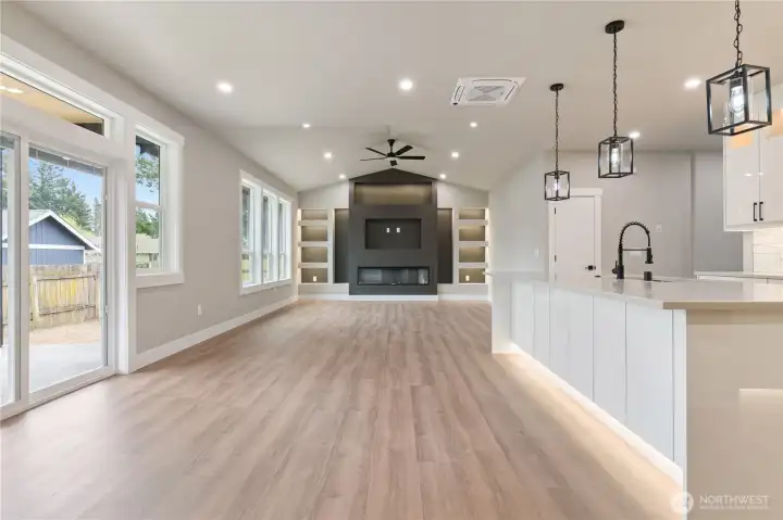 Open concept view from kitchen through to living room and covered patio door