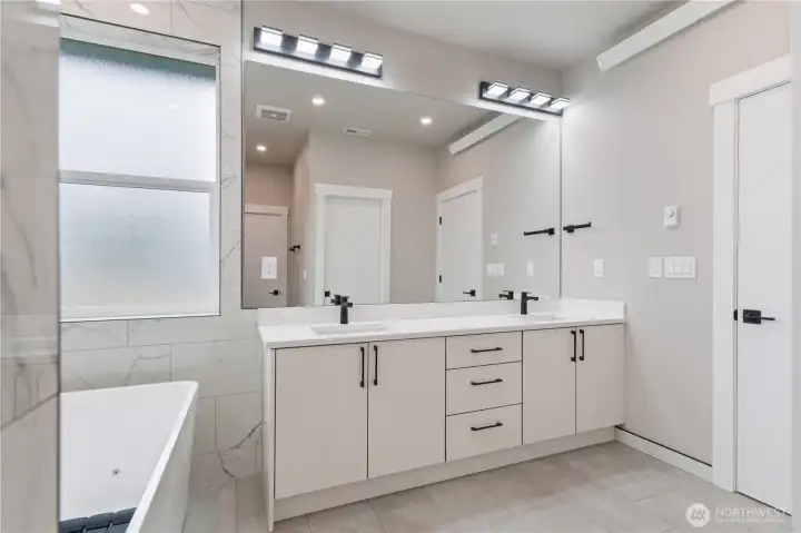 Primary bath dual-sink vanity with quartz countertop and custom cabinetry