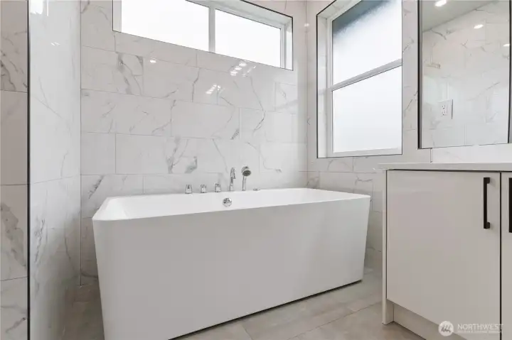 Primary bath soaking tub with natural light window above