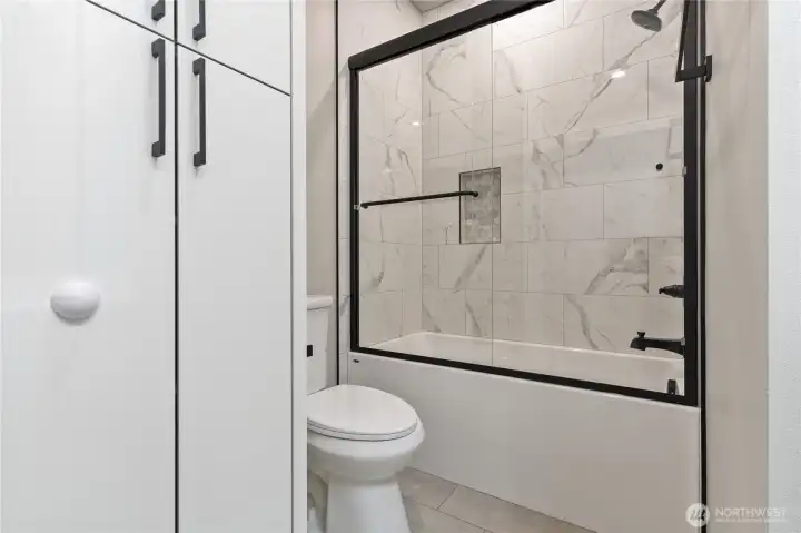 Secondary bathroom shower detail with black hardware