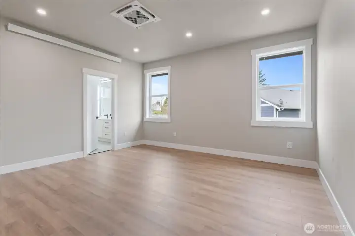 Bedroom with LVP flooring and natural light
