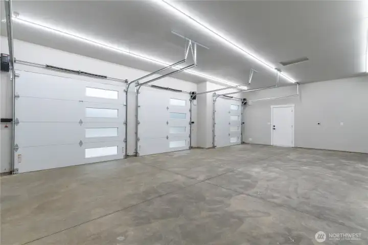 Three-car garage interior showing all three bays and interior access door