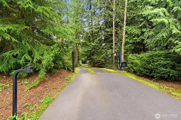 Gated entry with private driveway and landscaped grounds.