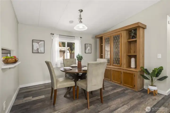 Dining room has built in cabinets and pass through window to the kitchen