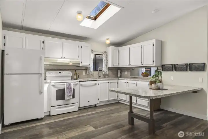 Kitchen has skylight and window over the sink