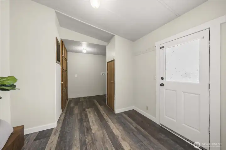 Back door entry leads to laundry room and has storage