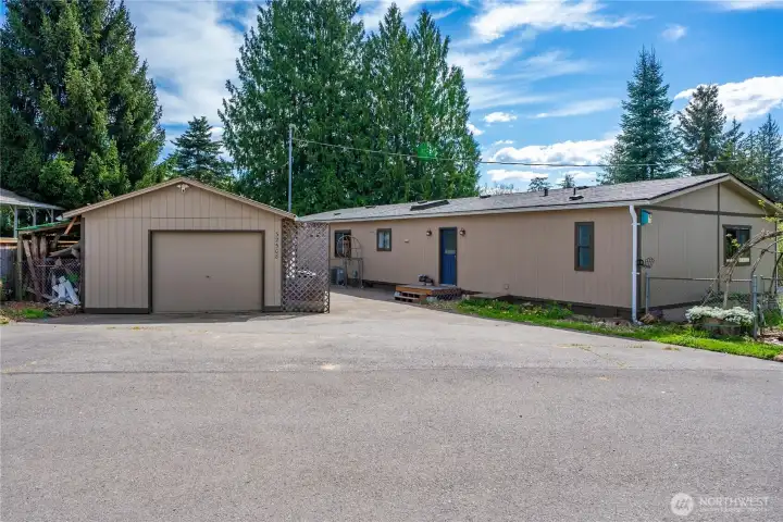 Back door, oversized garage, 4 uncovered parking spots