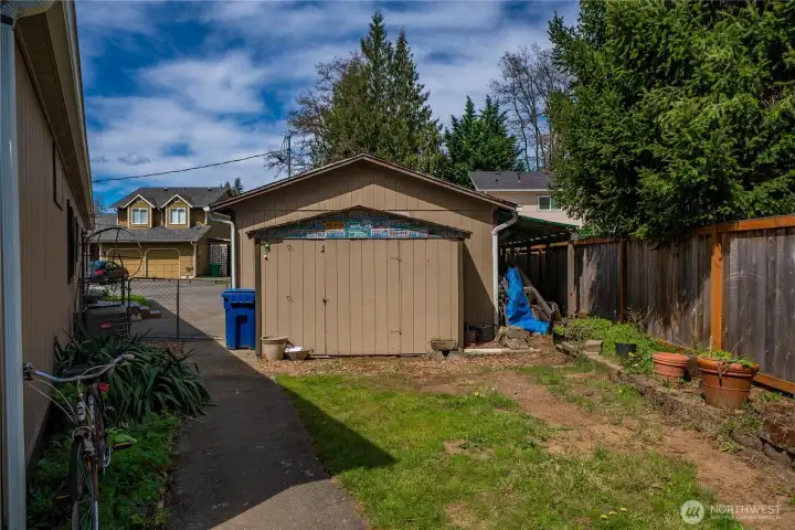 Large shelved storage shed attached to garage