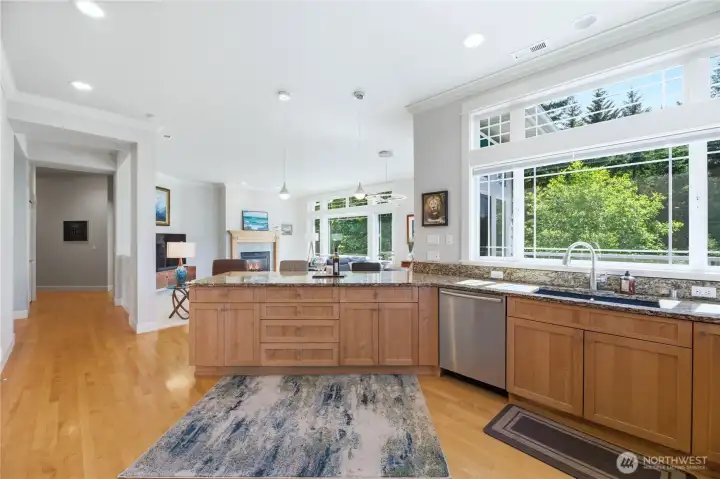The spacious kitchen has custom cabinets, granite counters, stainless appliances and tons of windows to let the natural light in