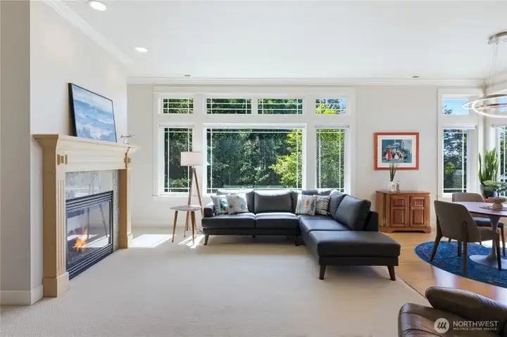 Living room has big picture window, gas fireplace and vaulted ceilings
